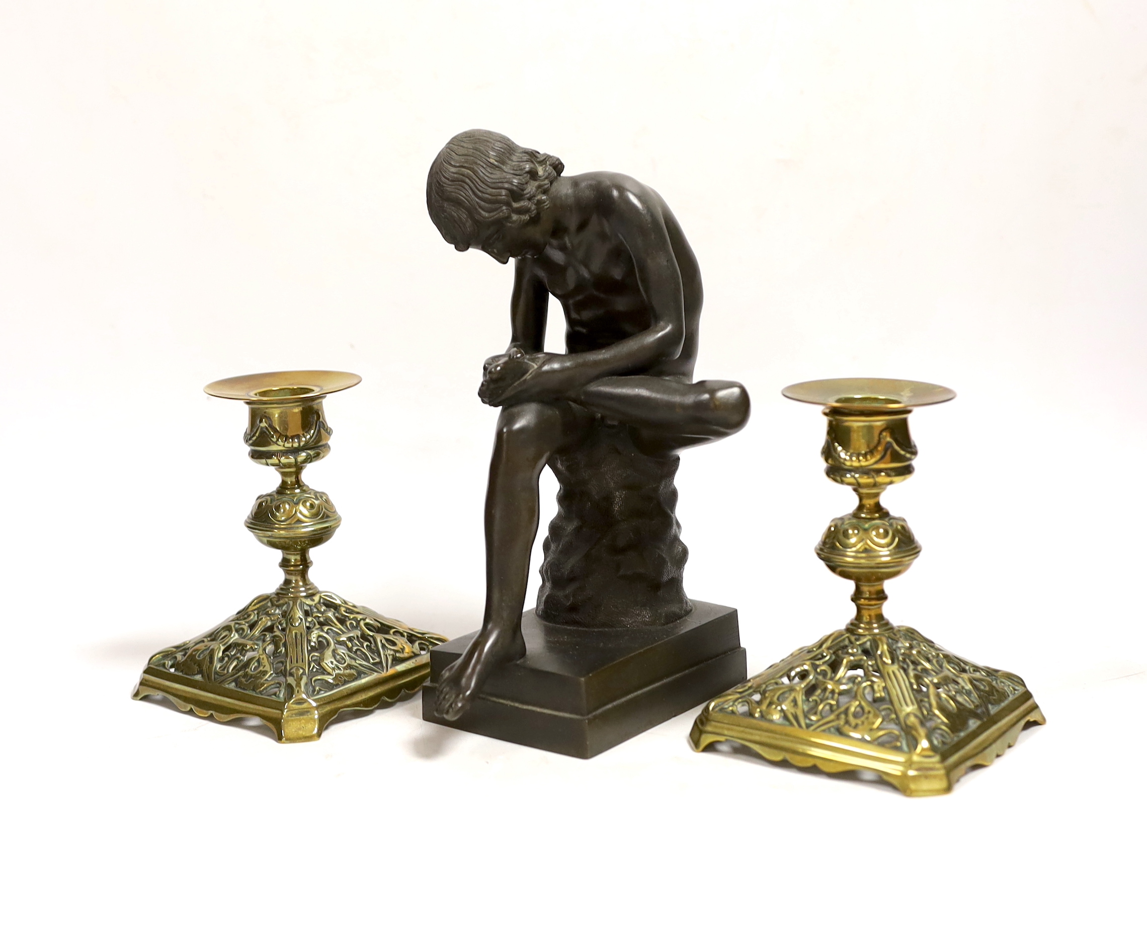 A bronze model of Spinario and a pair of Victorian dwarf candlesticks, lozenge mark to base, tallest 21cm